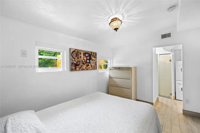 a bedroom with a bed and a chandelier