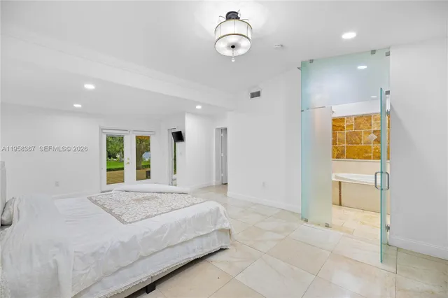 a spacious bedroom with a bed and a shower