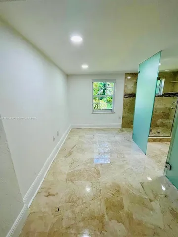 a view of a big room with furniture and front door