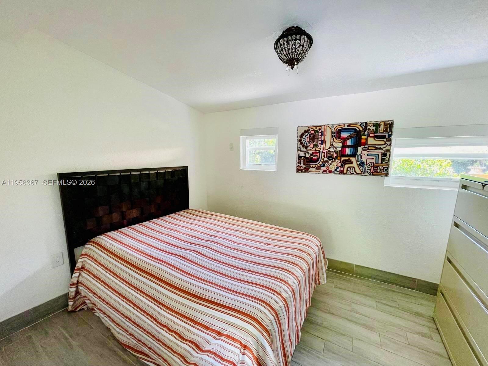 12300 Old Cutler Road, Unit 1 Pinecrest, FL 33156 - Photo 27 of 39 a bedroom with a bed and a window