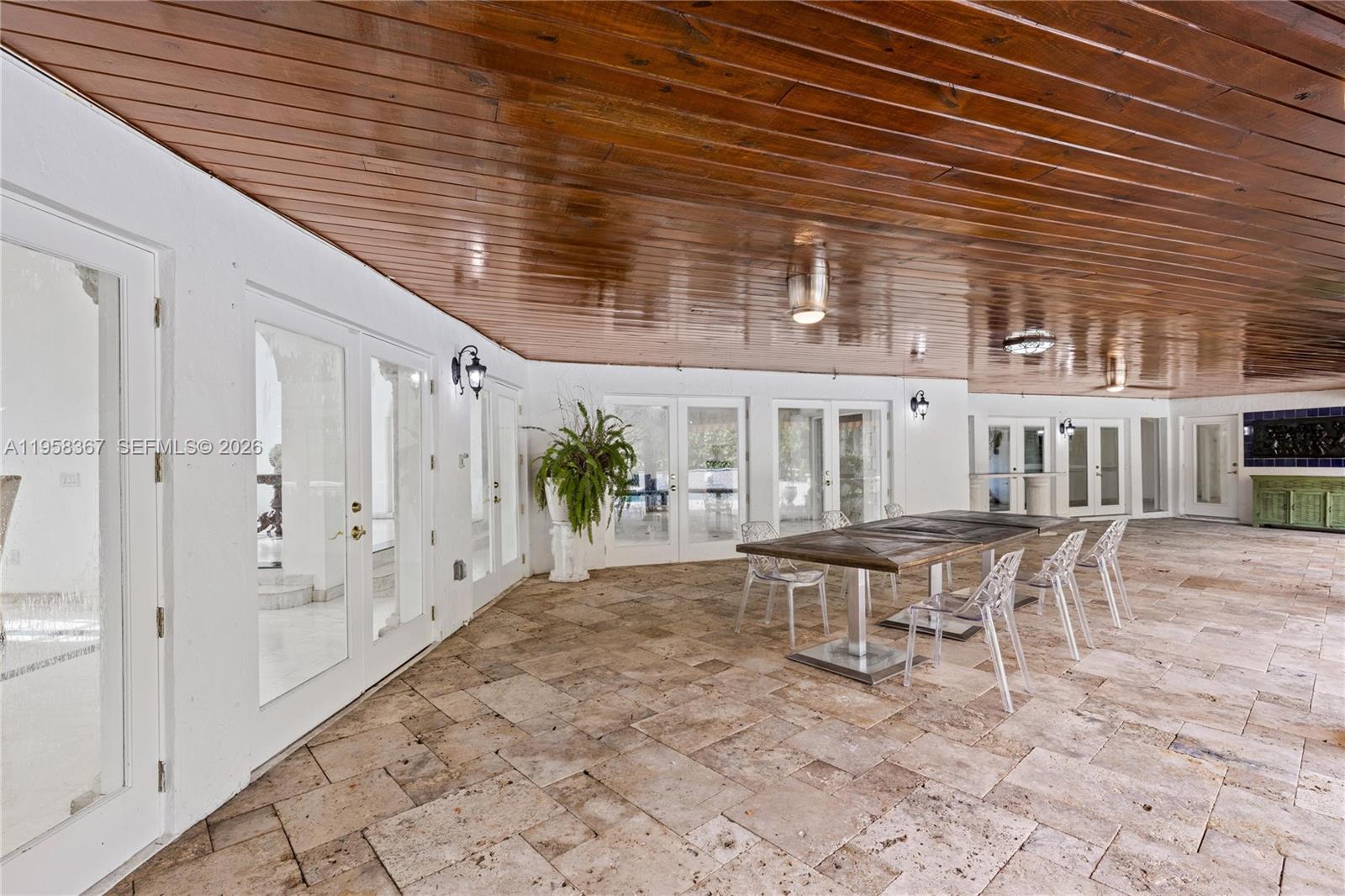 12300 Old Cutler Road, Unit 1 Pinecrest, FL 33156 - Photo 28 of 39 a view of a patio with table and chairs and potted plants