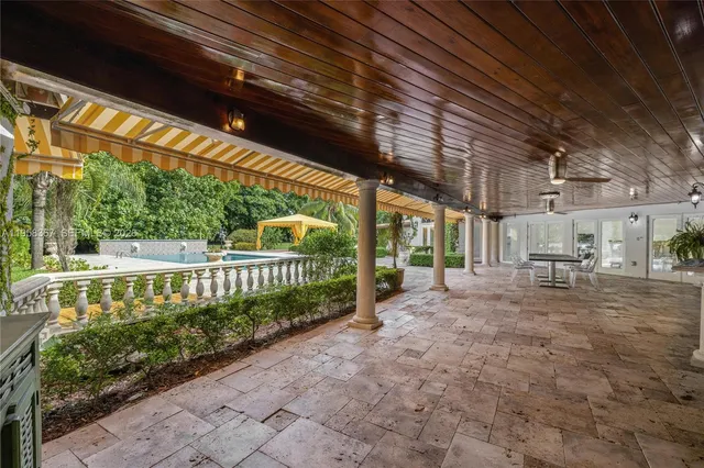 an outdoor view of house with swimming pool and garden