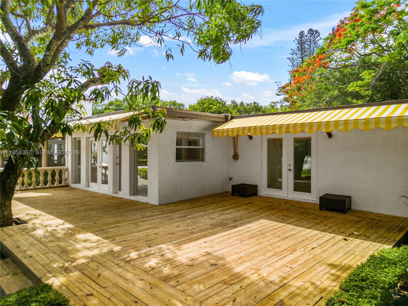 12300 Old Cutler Road, Unit 1 Pinecrest, FL 33156 - Photo 31 of 39 a view of a white house with a large tree