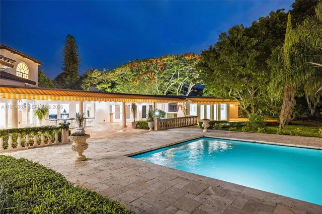 a view of a yard with plants and a fountain
