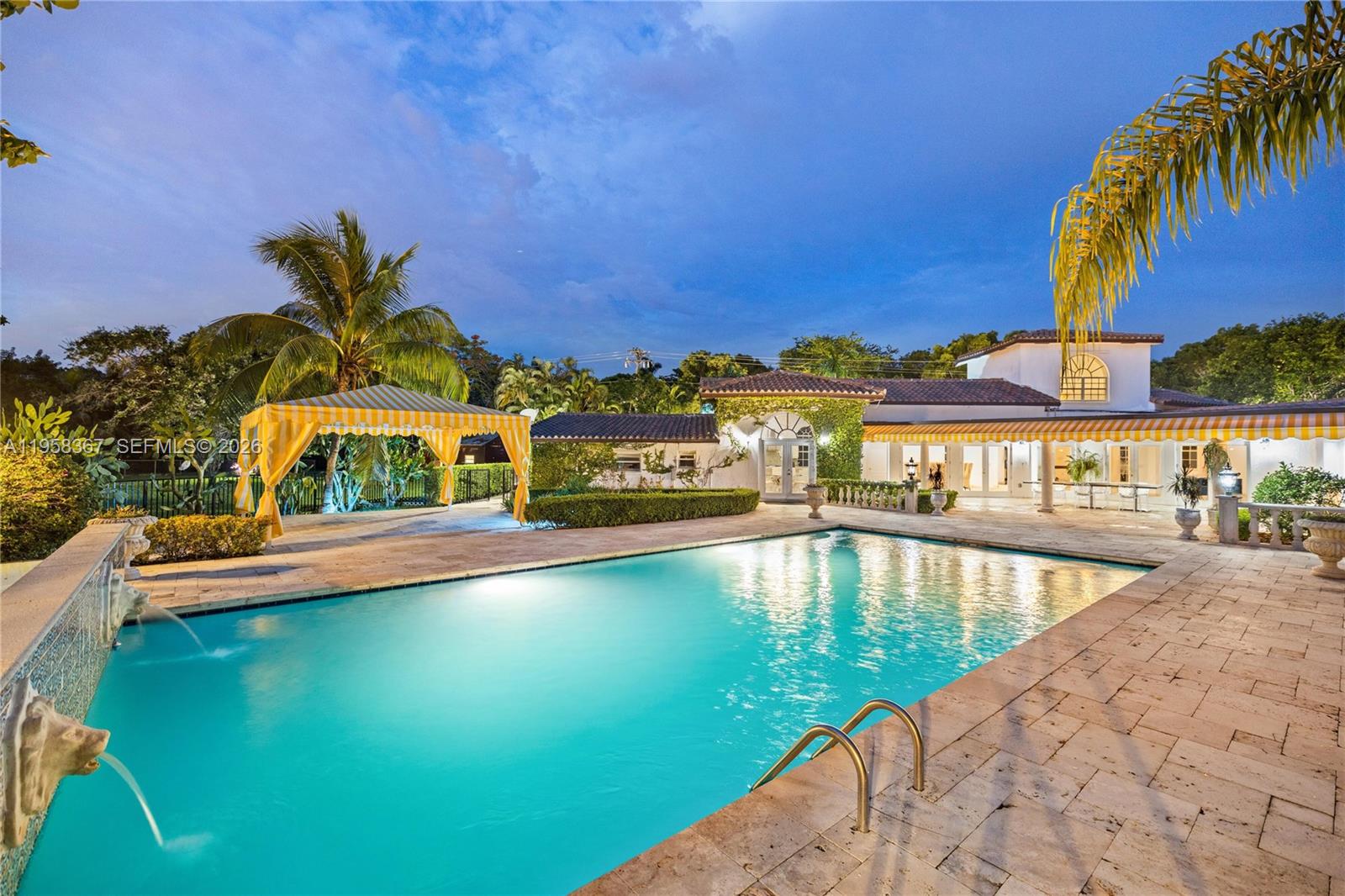 12300 Old Cutler Road, Unit 1 Pinecrest, FL 33156 - Photo 34 of 39 a view of a swimming pool with a lounge chairs