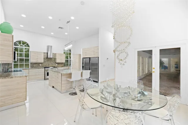 a living room with dining table and chairs