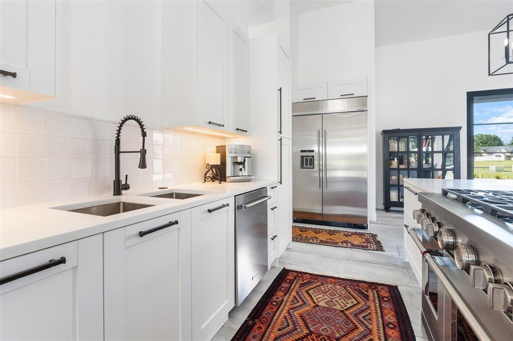 255 Private Road 5941 Emory, TX 75440 - Photo 14 of 39 Kitchen featuring white cabinetry, high quality appliances, sink, and tasteful backsplash