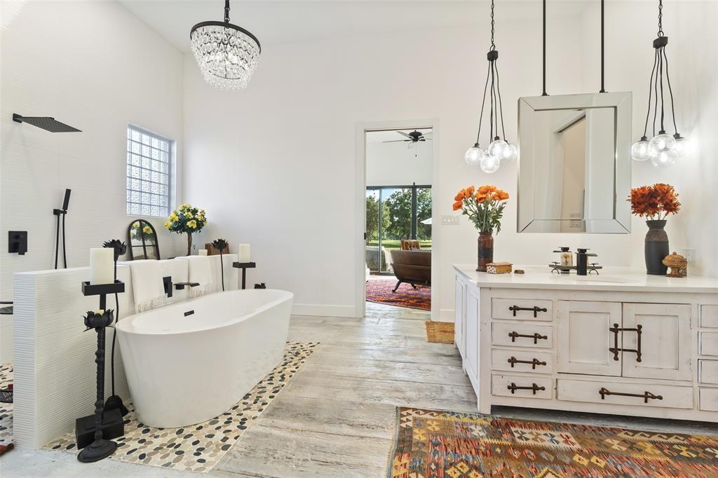 255 Private Road 5941 Emory, TX 75440 - Photo 21 of 39 Bathroom with vanity, a tub to relax in, plenty of natural light, and wood-type flooring