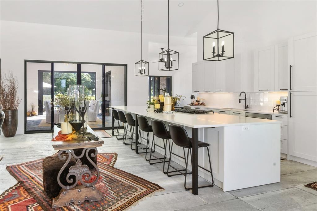 255 Private Road 5941 Emory, TX 75440 - Photo 8 of 39 Bar featuring sink, tasteful backsplash, stainless steel gas cooktop, white cabinets, and decorative light fixtures