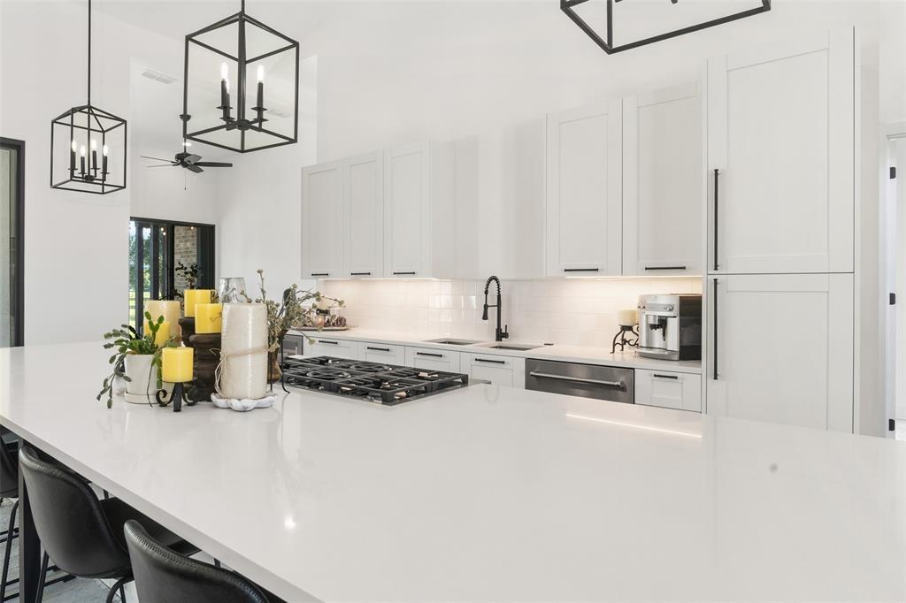 255 Private Road 5941 Emory, TX 75440 - Photo 10 of 39 Kitchen with a kitchen bar, sink, white cabinetry, pendant lighting, and stainless steel appliances