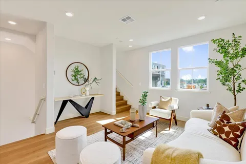 a living room with furniture and a clock