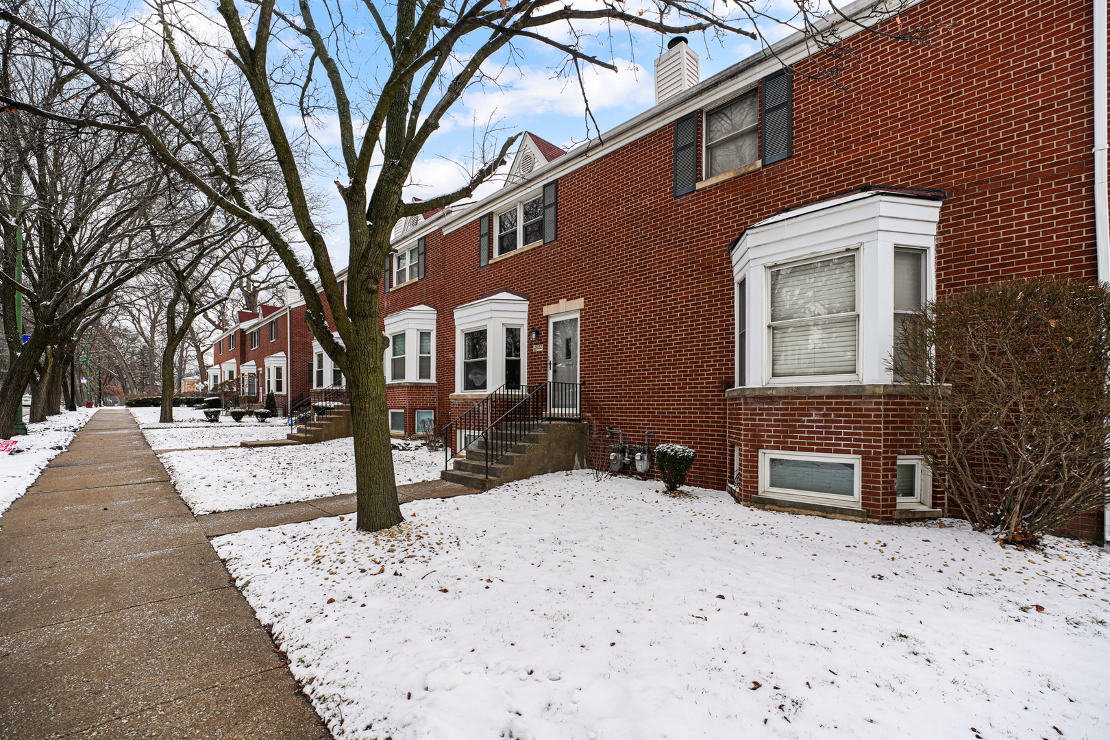1602 West 103rd Street Chicago, IL 60643 - Photo 21 of 22 a front view of a house with a yard covered with snow