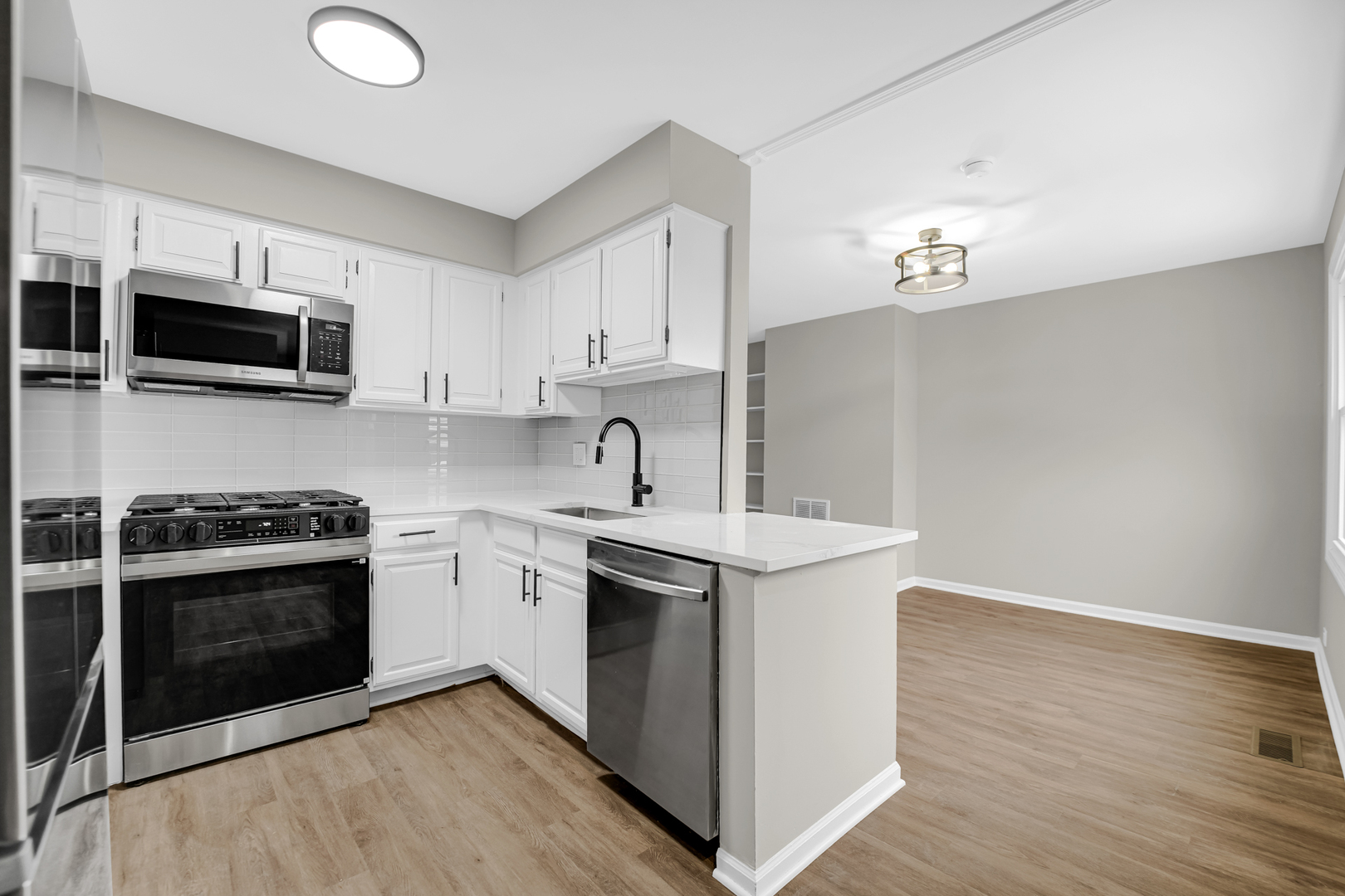 1602 West 103rd Street Chicago, IL 60643 - Photo 4 of 22 a kitchen with a sink stove and microwave