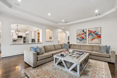 a living room with furniture and view of kitchen