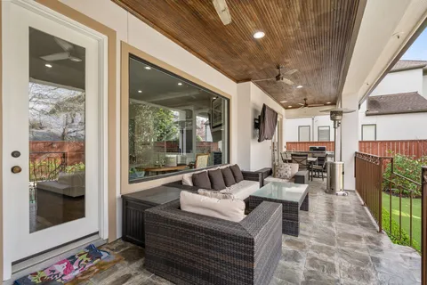 a living room with furniture and a floor to ceiling window
