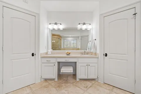 a spacious bathroom with a double vanity sink and a mirror
