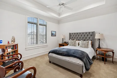 a bedroom with a bed next to a window