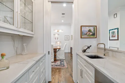 a kitchen with stainless steel appliances a sink a stove and a wooden floor