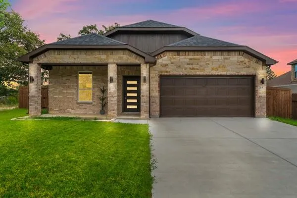 a front view of a house with a garden