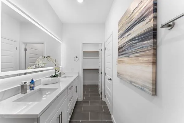 a bathroom with a double vanity sink toilet and shower