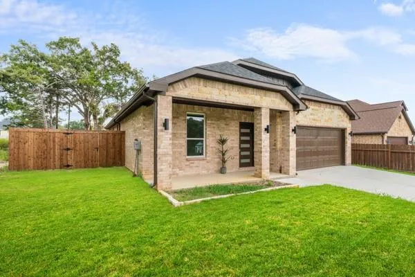 a front view of a house with a yard