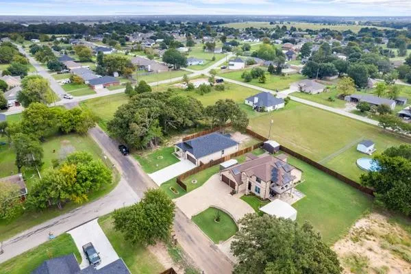 a white house that has a tree in front of it