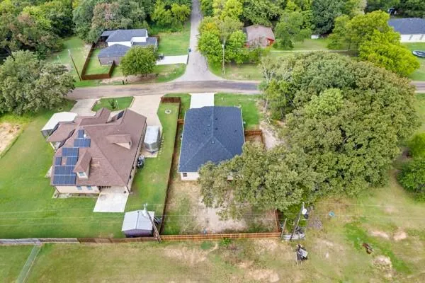 an aerial view of a house with a big yard