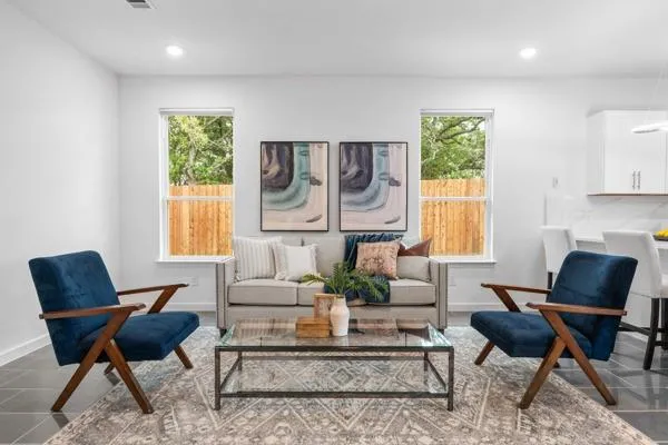 a living room with furniture and a potted plant