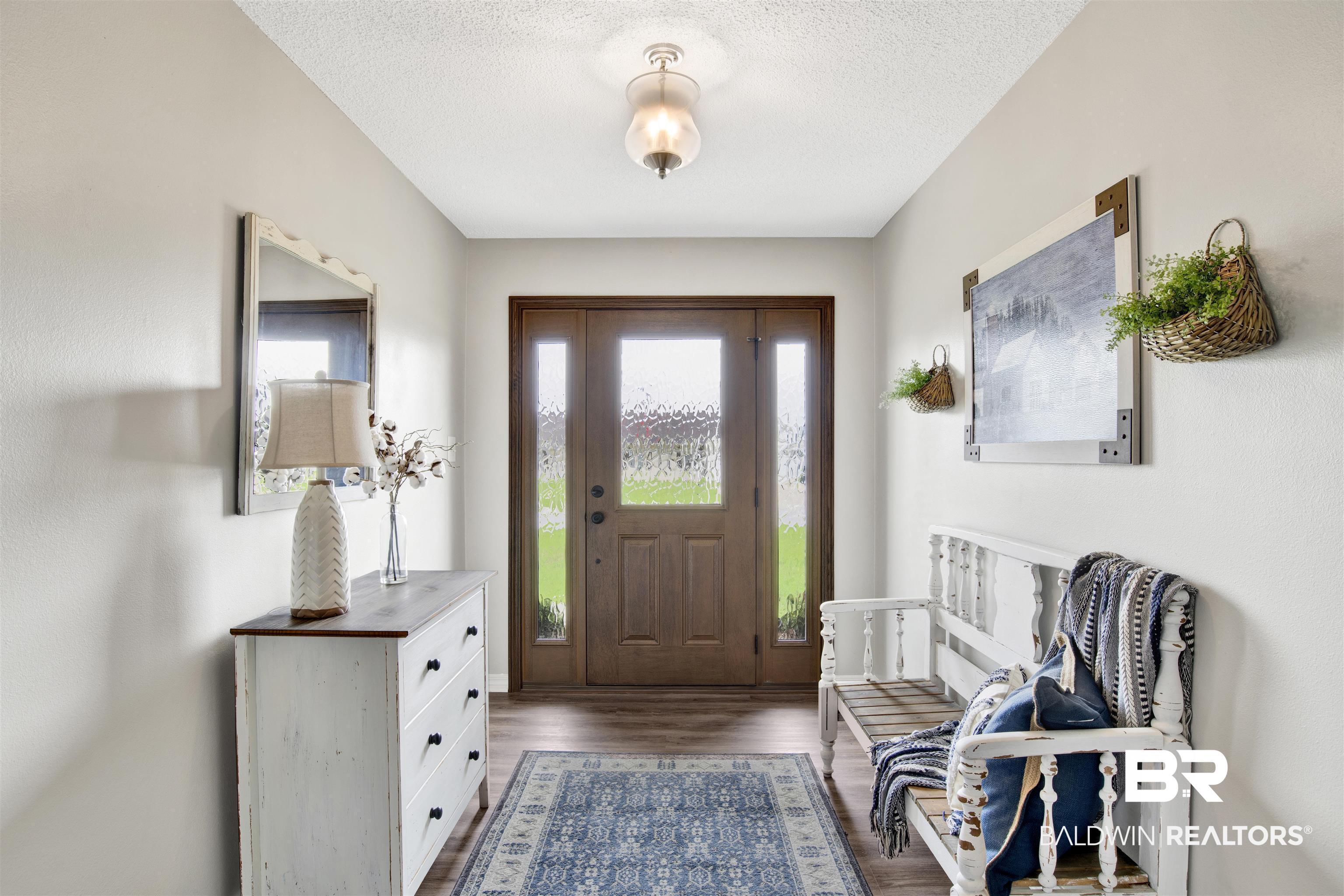 17483 East View Loop Foley, AL 36535 - Photo 7 of 30 Entryway featuring dark hardwood / wood-style floors and a textured ceiling