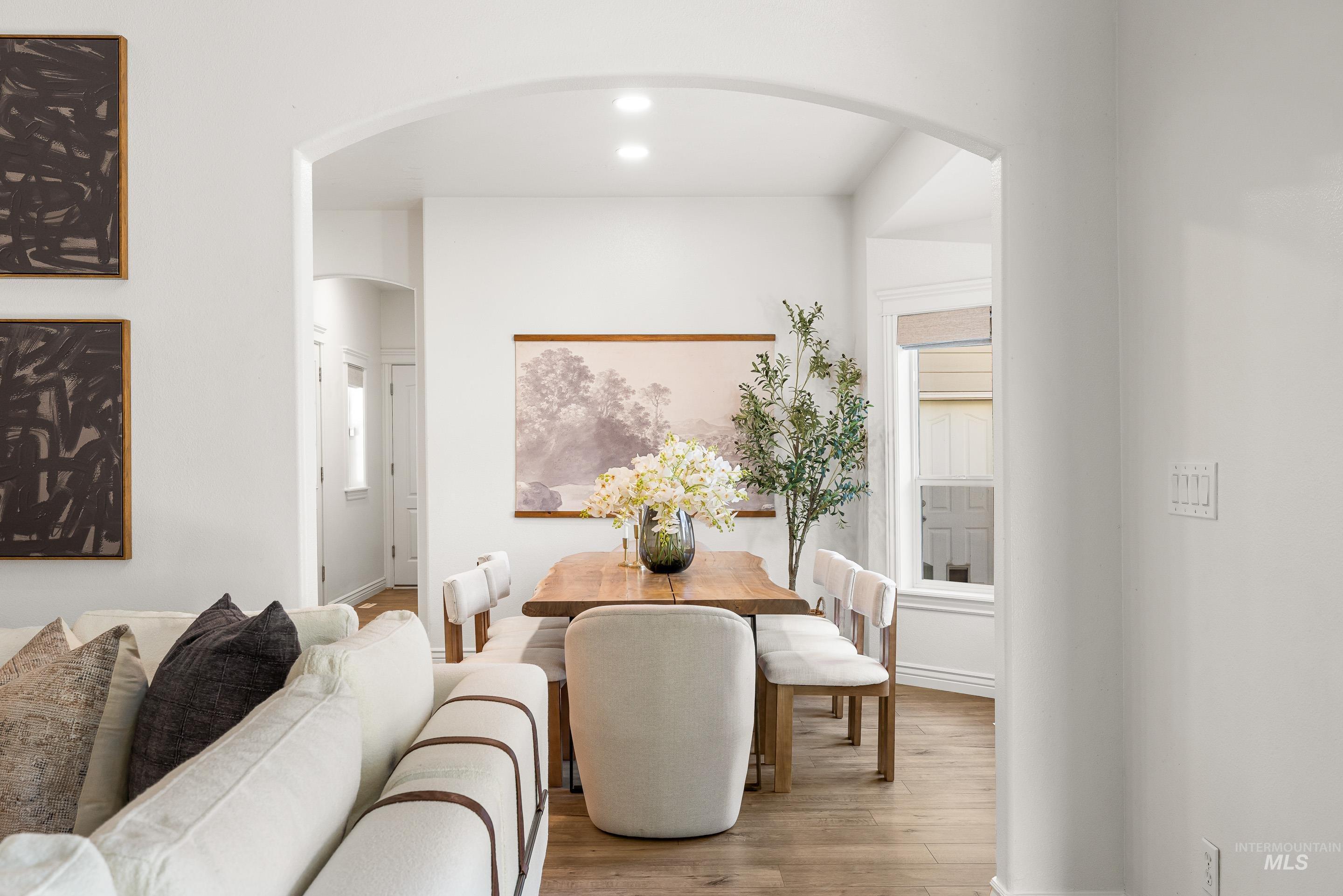 1197 North Cove Colony Way Eagle, ID 83616 - Photo 19 of 50 Dining room featuring arched walkways, wood finished floors, and recessed lighting