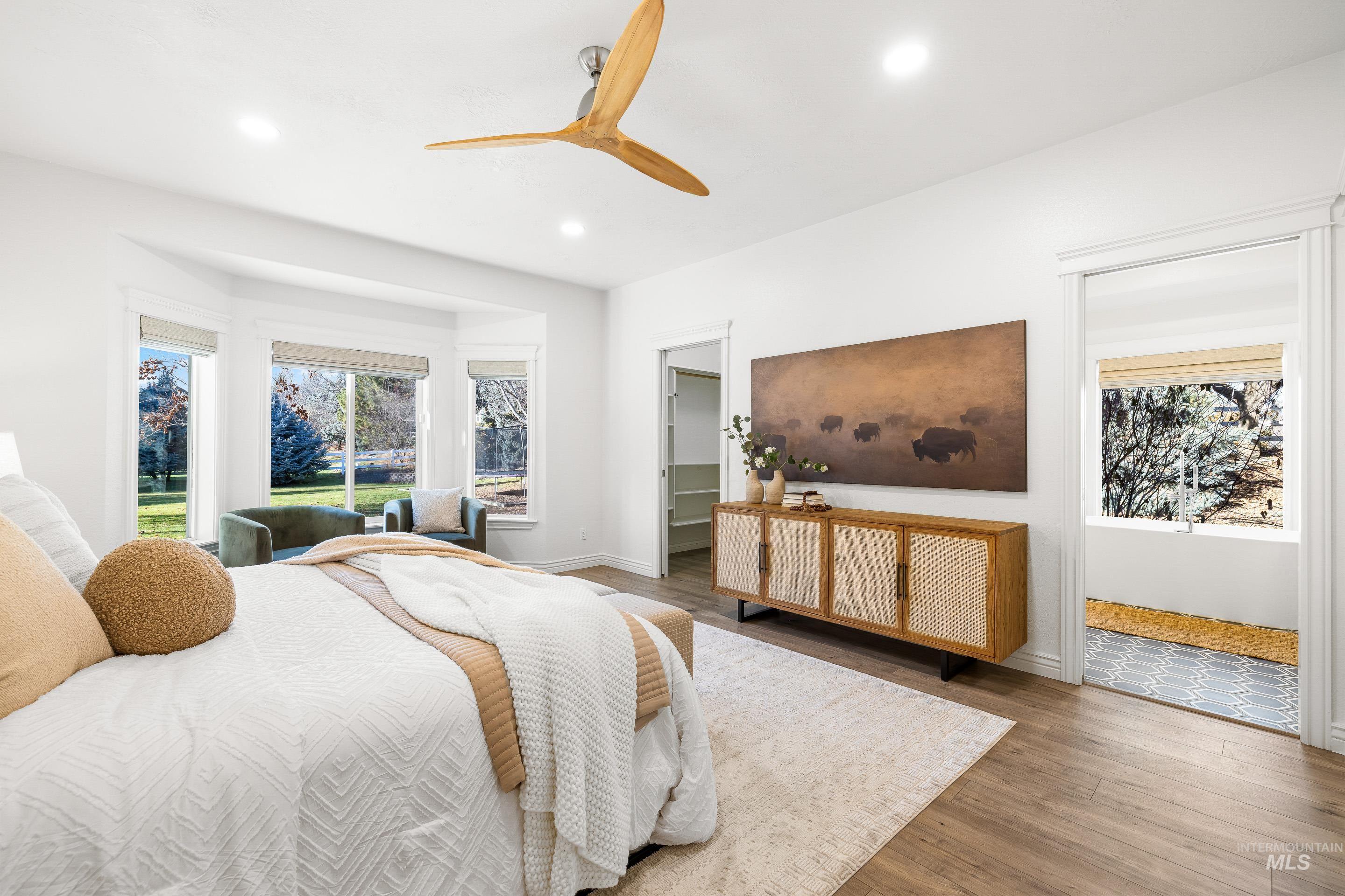 1197 North Cove Colony Way Eagle, ID 83616 - Photo 27 of 50 Bedroom featuring a walk in closet, wood finished floors, a ceiling fan, and recessed lighting