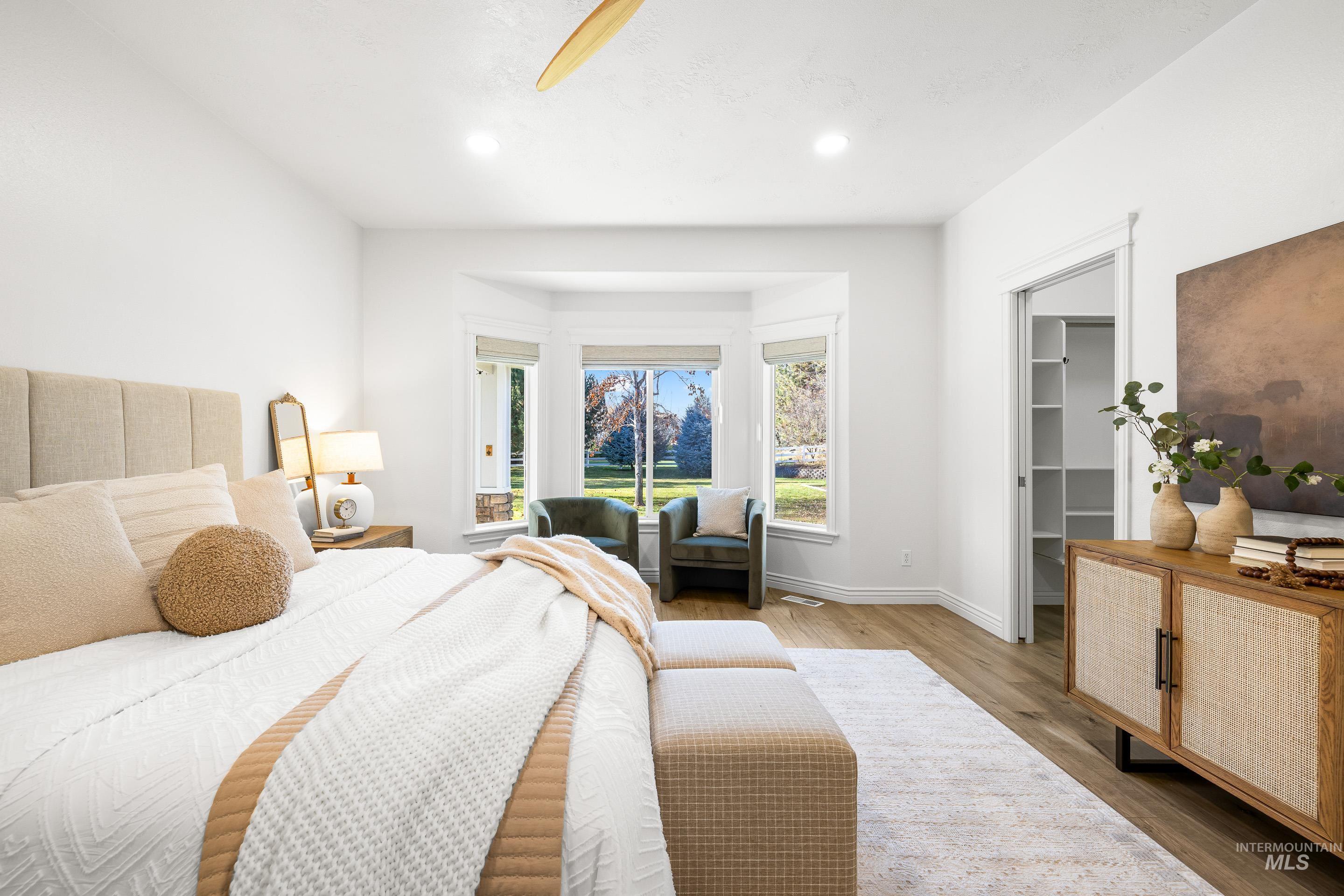 1197 North Cove Colony Way Eagle, ID 83616 - Photo 29 of 50 Bedroom with a spacious closet, wood finished floors, a ceiling fan, and recessed lighting