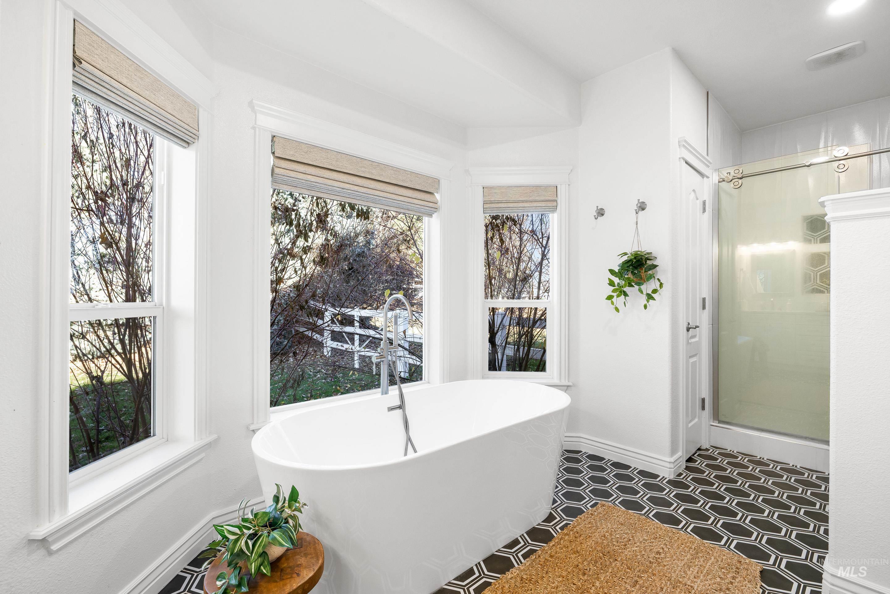 1197 North Cove Colony Way Eagle, ID 83616 - Photo 31 of 50 Full bathroom featuring a stall shower and a freestanding bath