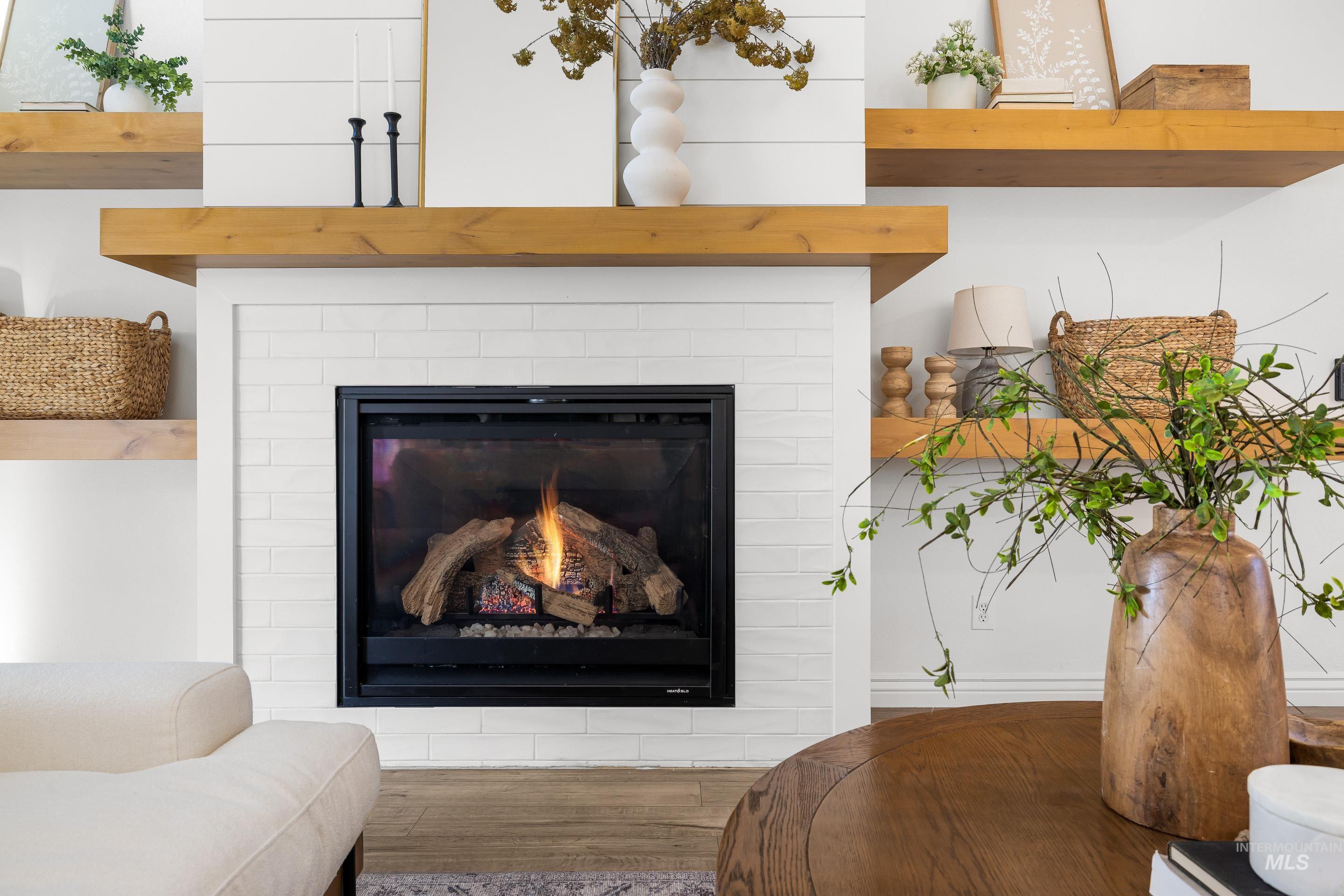 1197 North Cove Colony Way Eagle, ID 83616 - Photo 8 of 50 Detailed view of wood finished floors and a glass covered fireplace