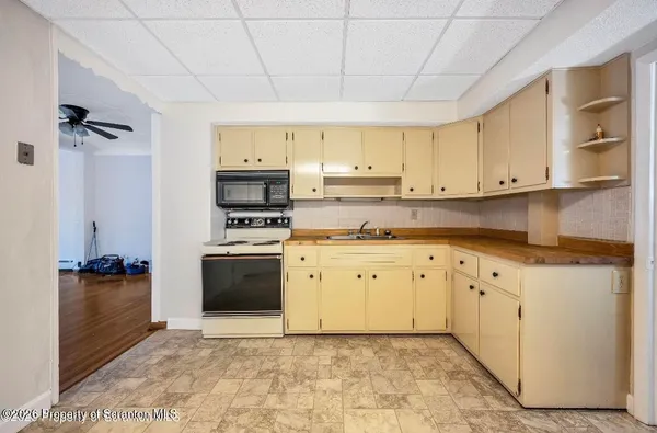 a kitchen with granite countertop cabinets and steel stainless steel appliances