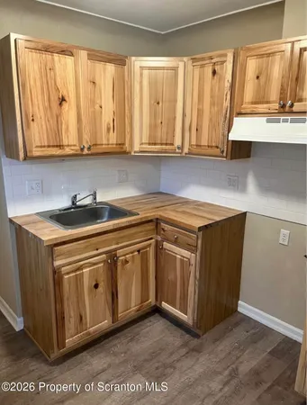 a kitchen with stainless steel appliances granite countertop a sink and a stove
