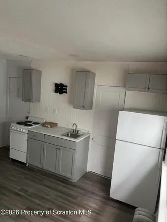 a kitchen with a sink and a stove top oven