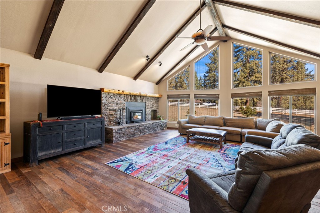 59331 Devils Ladder Road Mountain Center, CA 92561 - Photo 12 of 74 a living room with furniture a flat screen tv and a floor to ceiling window