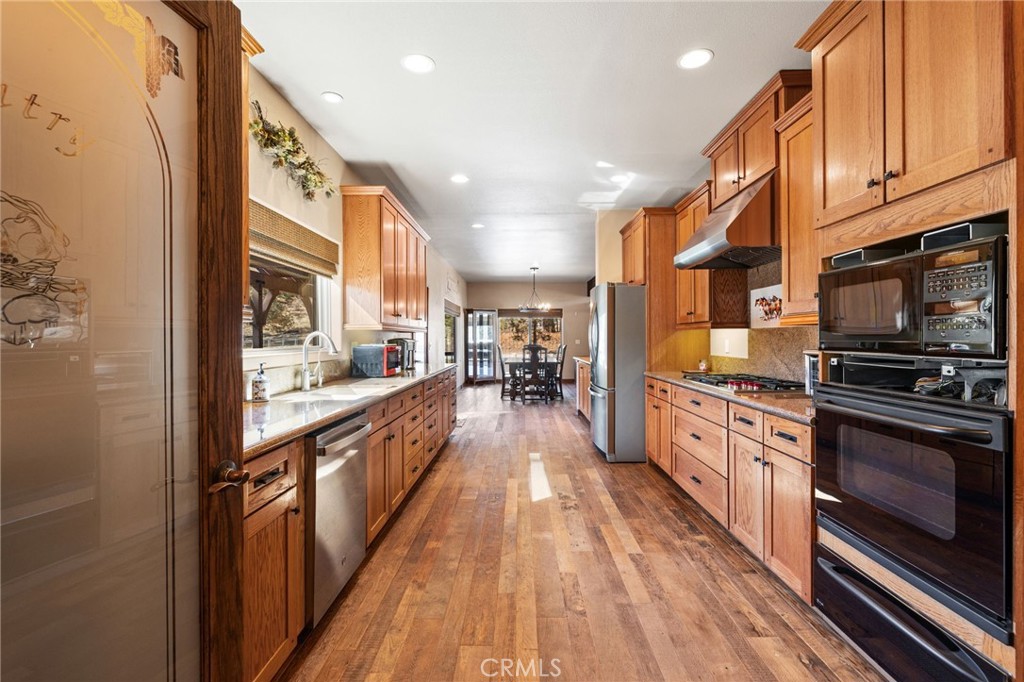 59331 Devils Ladder Road Mountain Center, CA 92561 - Photo 21 of 74 a large kitchen with stainless steel appliances granite countertop a large counter top a stove and a refrigerator