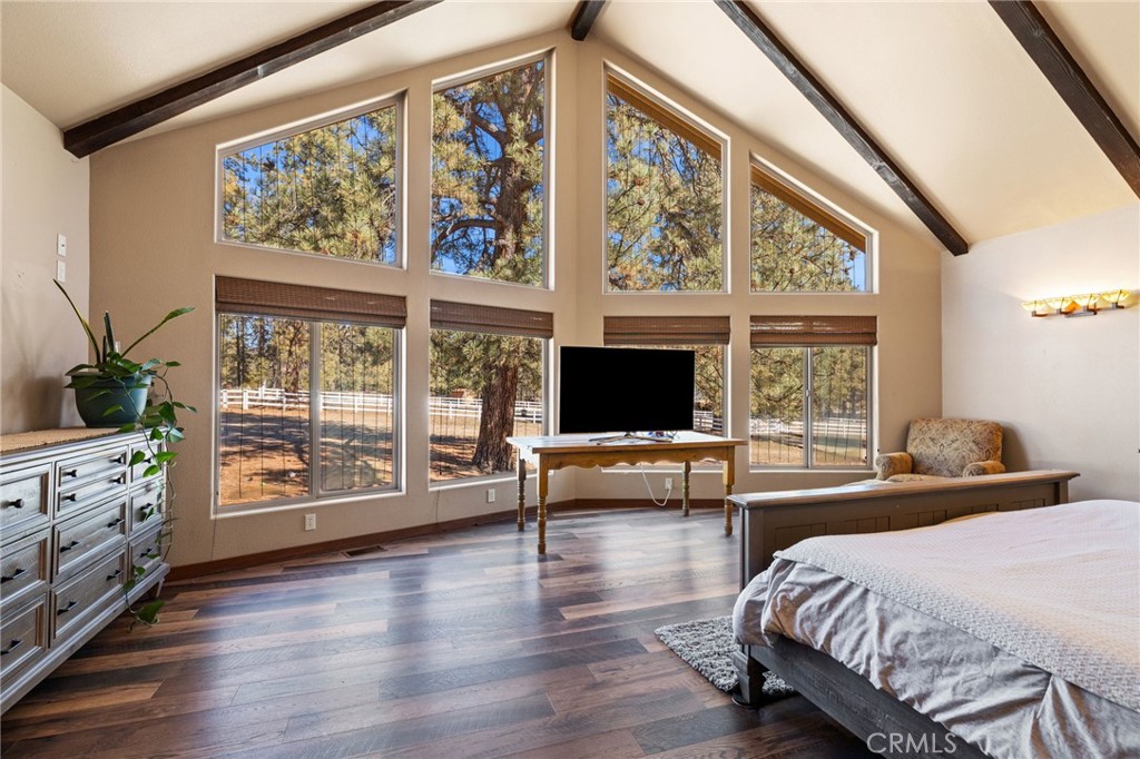 59331 Devils Ladder Road Mountain Center, CA 92561 - Photo 29 of 74 a bedroom with furniture a flat screen tv and a large window