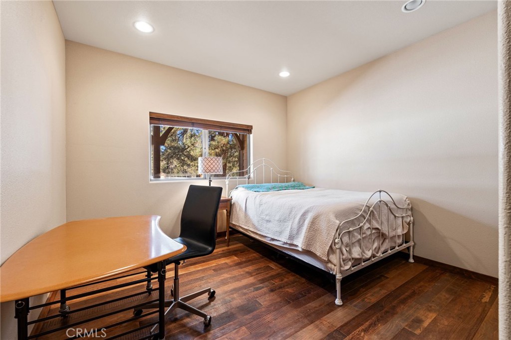 59331 Devils Ladder Road Mountain Center, CA 92561 - Photo 37 of 74 a bedroom with a bed a desk and chair