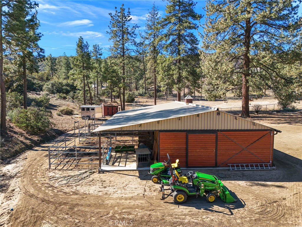 59331 Devils Ladder Road Mountain Center, CA 92561 - Photo 50 of 74 a view of a patio with table and chairs under an umbrella
