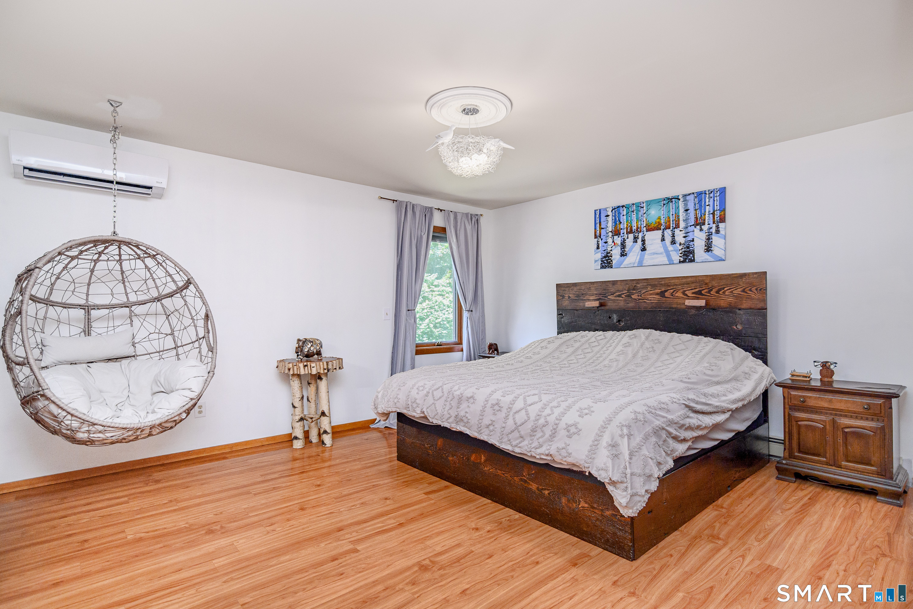 3 Spring Wood Lane New Fairfield, CT 06812 - Photo 4 of 28 a bedroom with a large bed and a chandelier