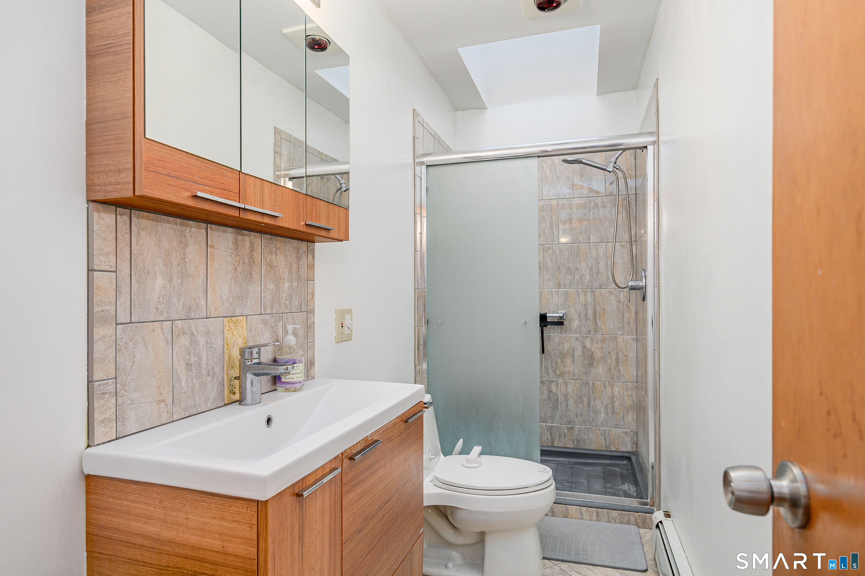 3 Spring Wood Lane New Fairfield, CT 06812 - Photo 6 of 28 a bathroom with a sink toilet and shower