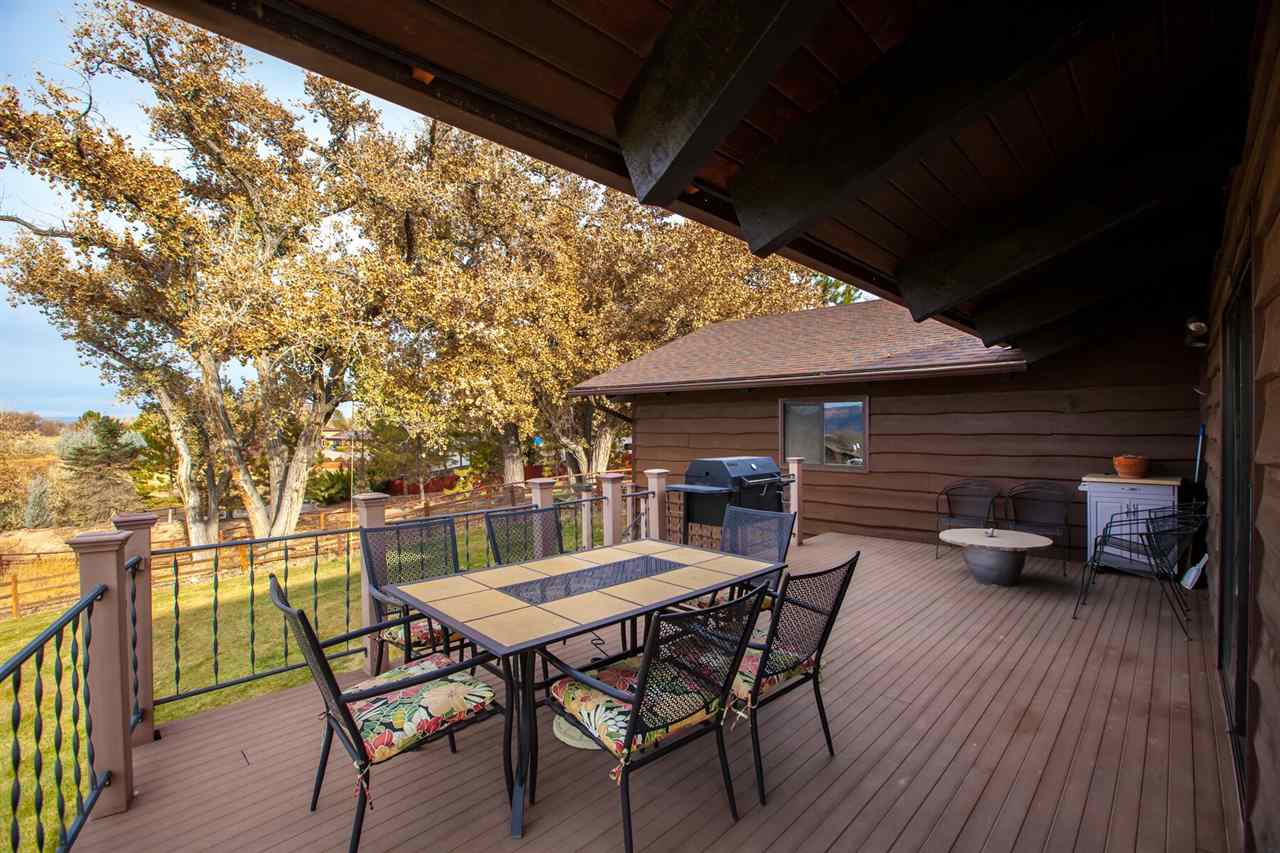 735 25 Road Grand Junction, CO 81505 - Photo 3 of 27 a view of a patio with table and chairs and wooden floor