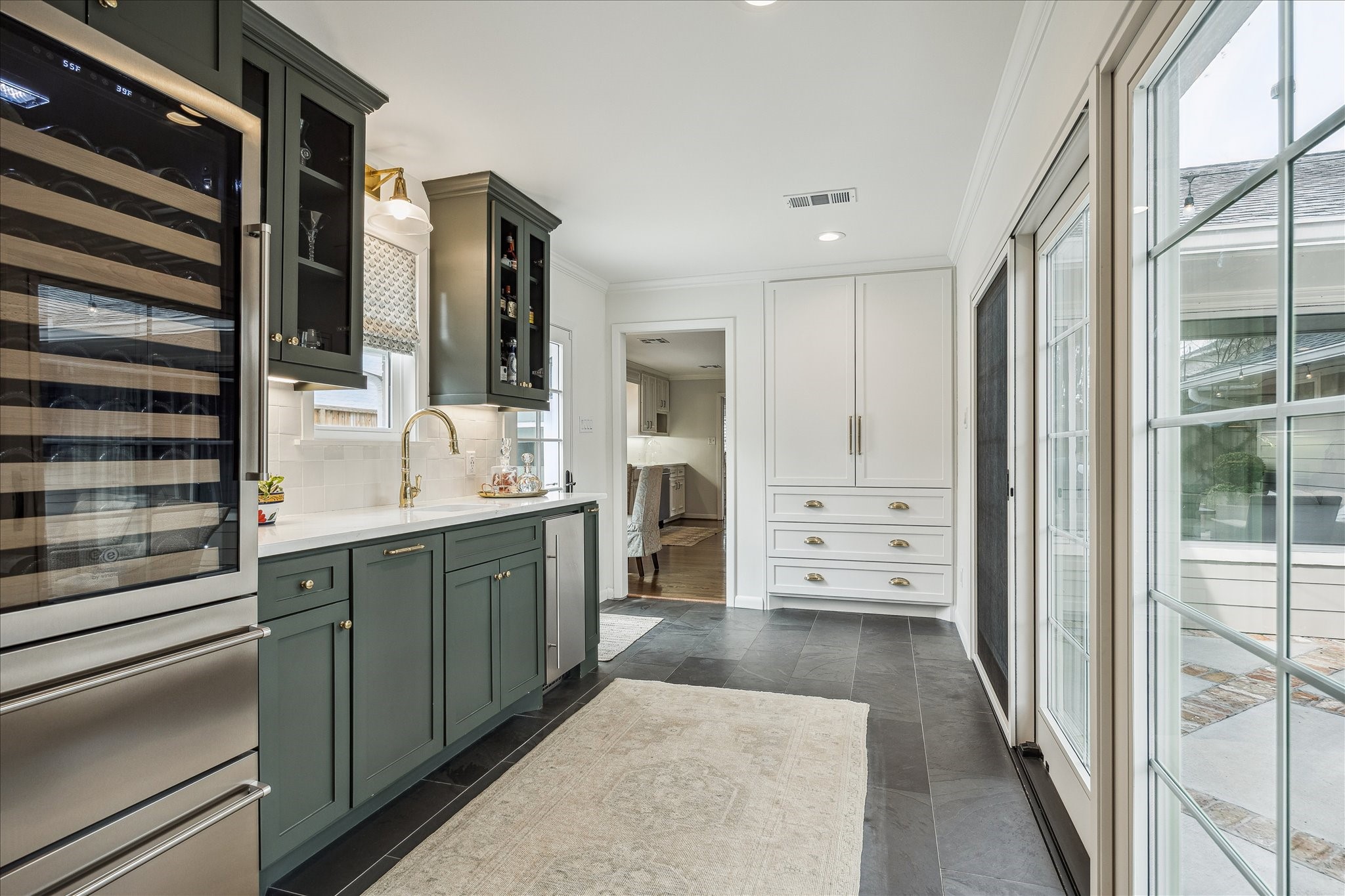 5655 Overbrook Lane Houston, TX 77056 - Photo 17 of 36 Added on by the current owner, this space adjoins the home to the 2-car garage, creating an attached garage and a beautiful focal point of the home perfect for those who love to entertain!