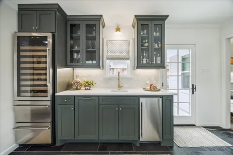a bathroom with a sink and mirror with bathtub