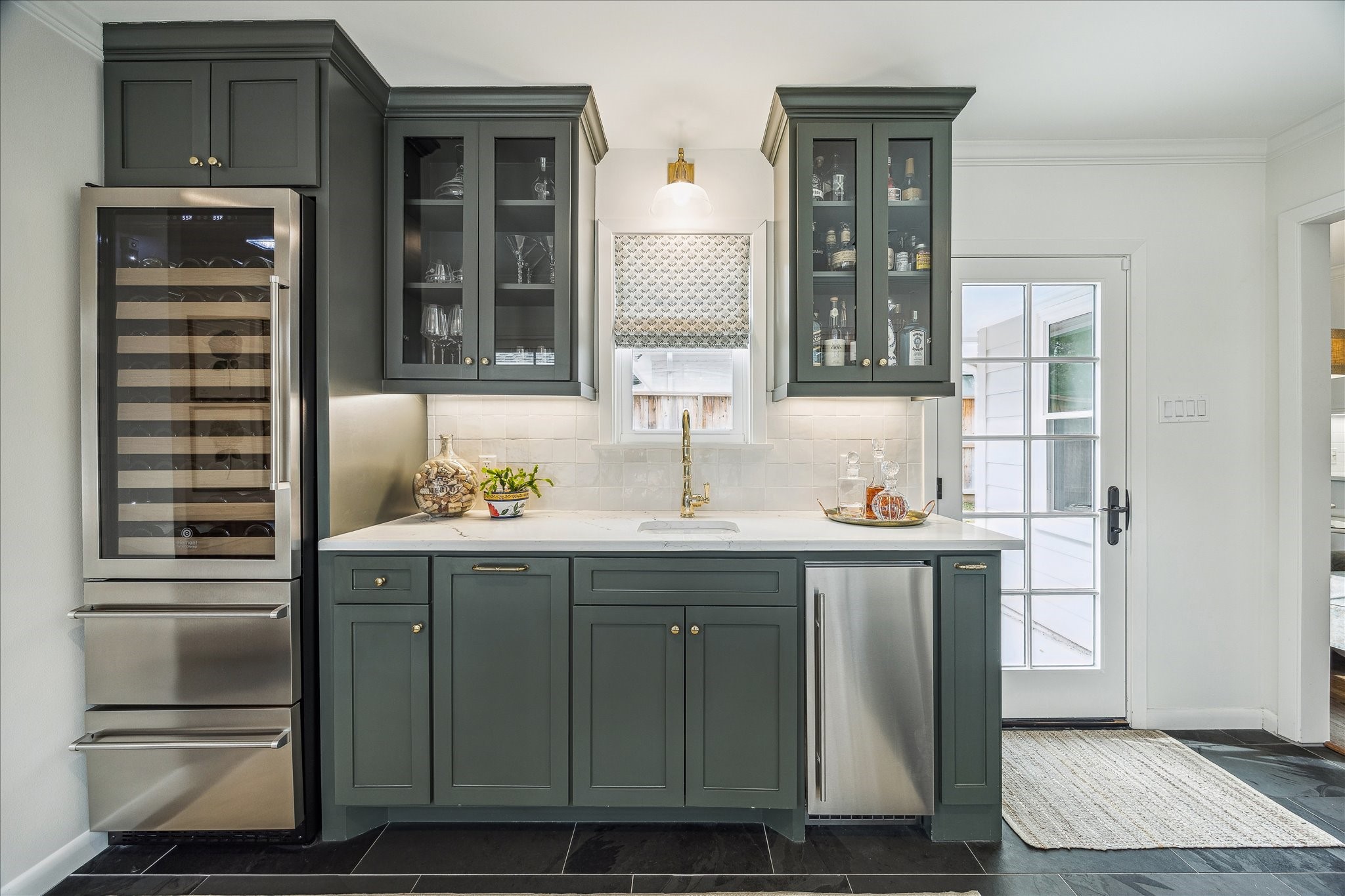 5655 Overbrook Lane Houston, TX 77056 - Photo 20 of 36 This wet bar includes quartz countertops, Scotsman ice machine, an additional sink, and a beverage refrigerator column with beverage drawers below.