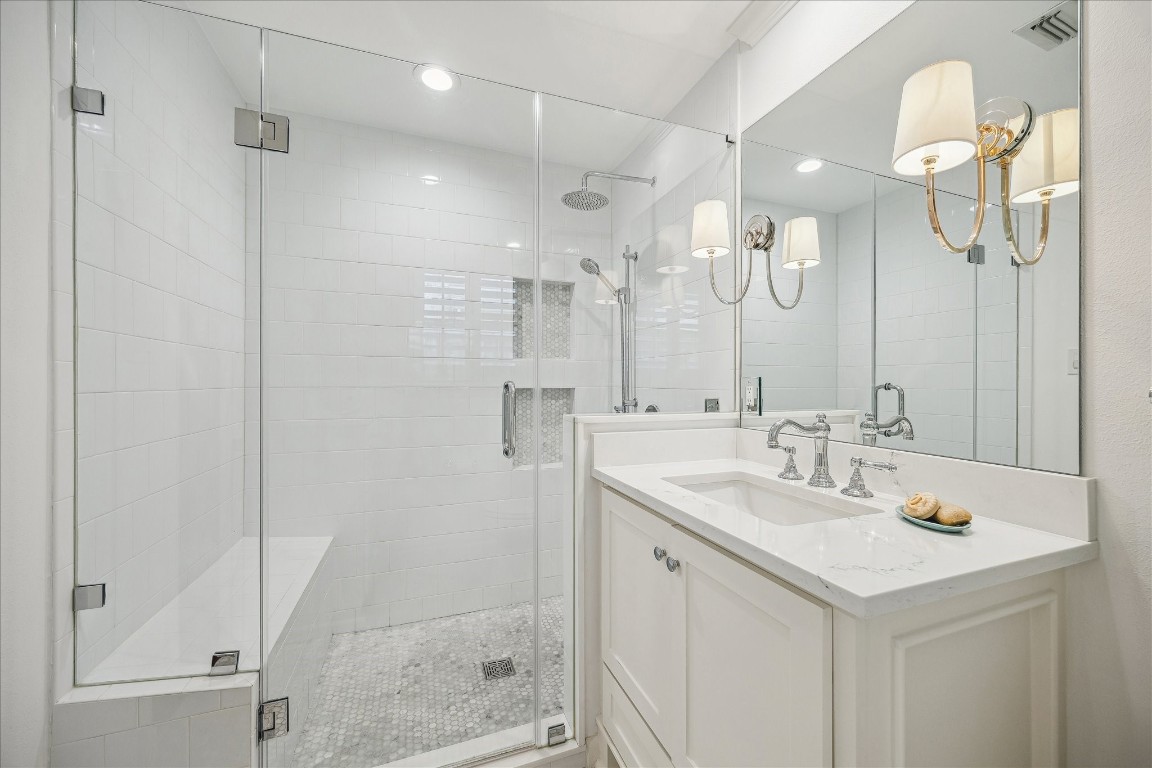 5655 Overbrook Lane Houston, TX 77056 - Photo 25 of 36 Primary bathroom fully gutted in '19-'20 to include new shower, tile, cabinetry, Rohl faucet, toilet, tile floor, light and plumbing fixtures and quartz countertops.