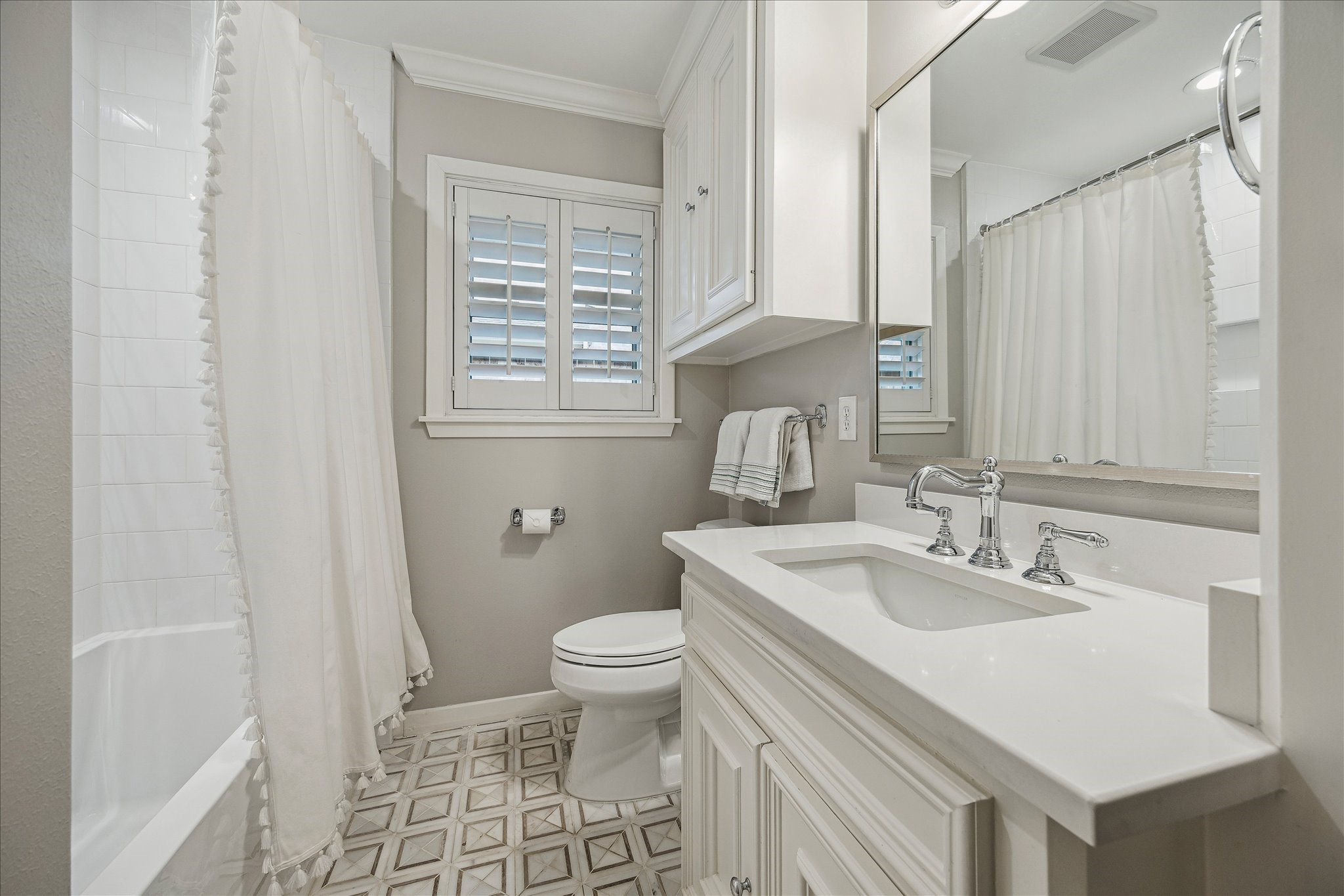 5655 Overbrook Lane Houston, TX 77056 - Photo 27 of 36 Hall bath with beautiful updates to include new tub, tile, toilet, marble tile floor, Rohl faucet, quartz countertops and plumbing and lighting fixtures.